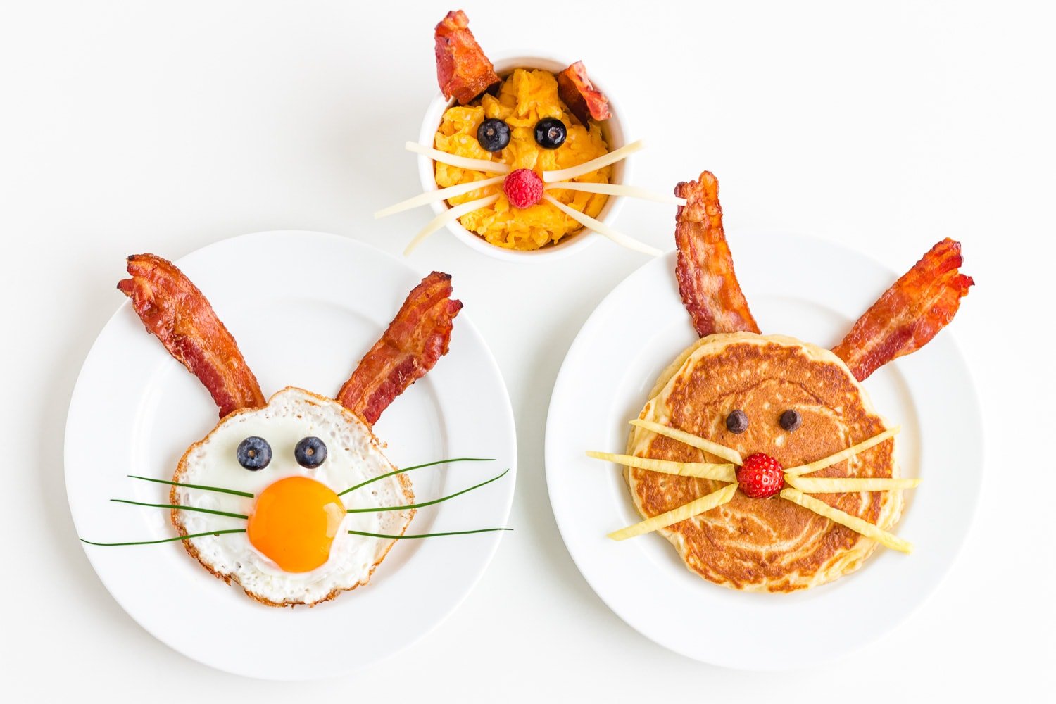 Three versions of an Easter Bunny themed breakfast including a bunny pancake, bunny scrambled eggs and a fried egg bunny.