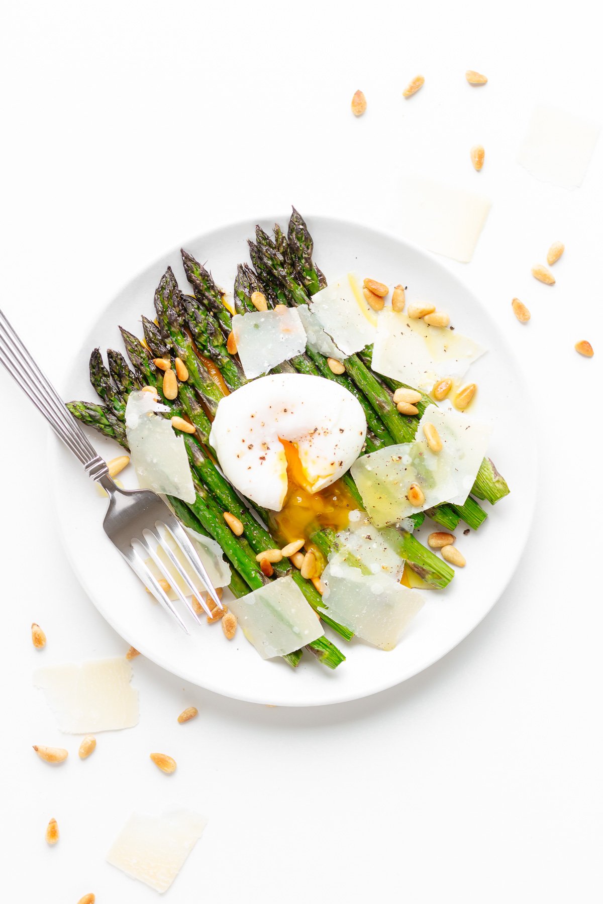 Roasted asparagus salad topped with a poached egg, parmesan and toasted pine nuts.