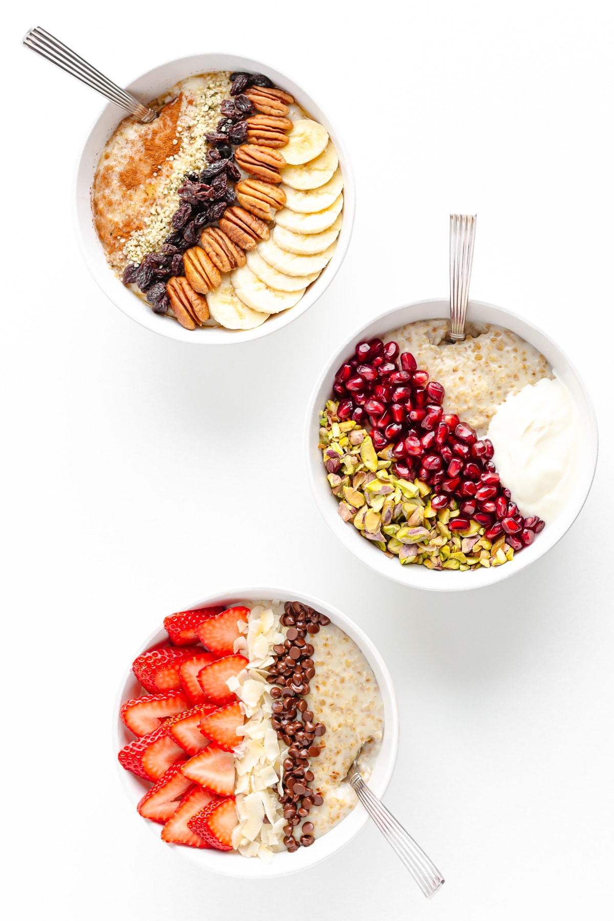 Three bowls of steel cut oatmeal with different toppings.