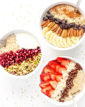 Three bowls of steel cut oats with different toppings on each bowl.