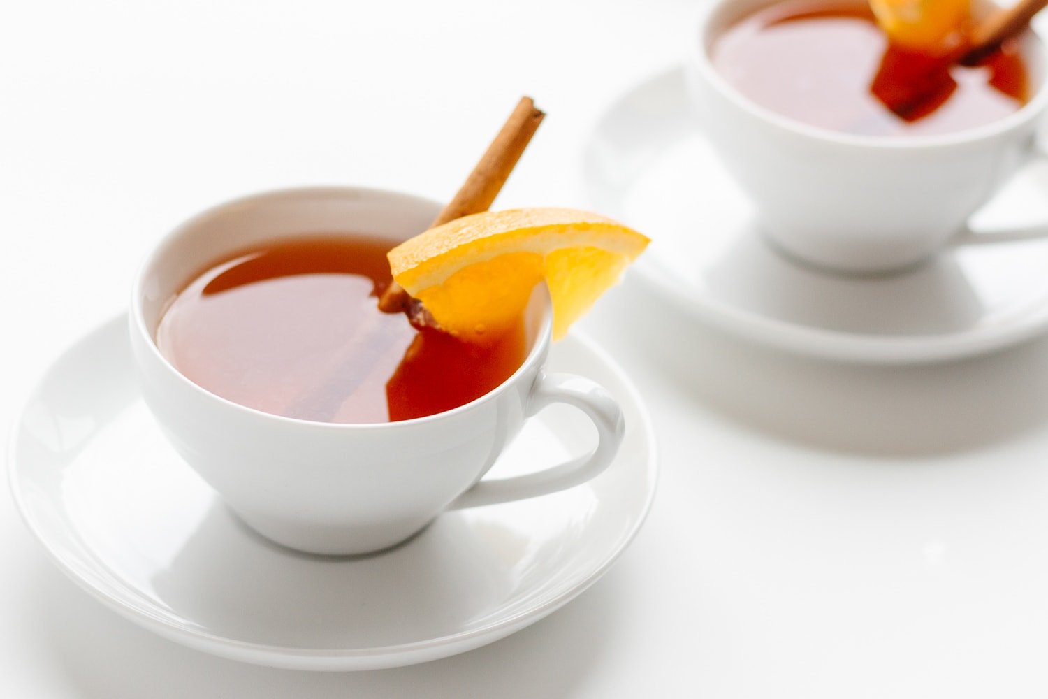 Two white tea cups filled with Orange |Spice Mulled Tea