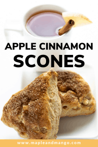 Two apple cinnamon scones sitting in front of a glass of apple cider with text overlay that reads "Apple Cinnamon Scones".