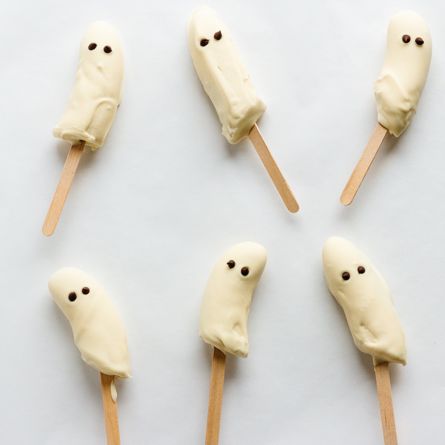 Bananas that are halved, placed on popsicle sticks and dipped in white chocolate with chocolate chip eyes to look like ghosts.