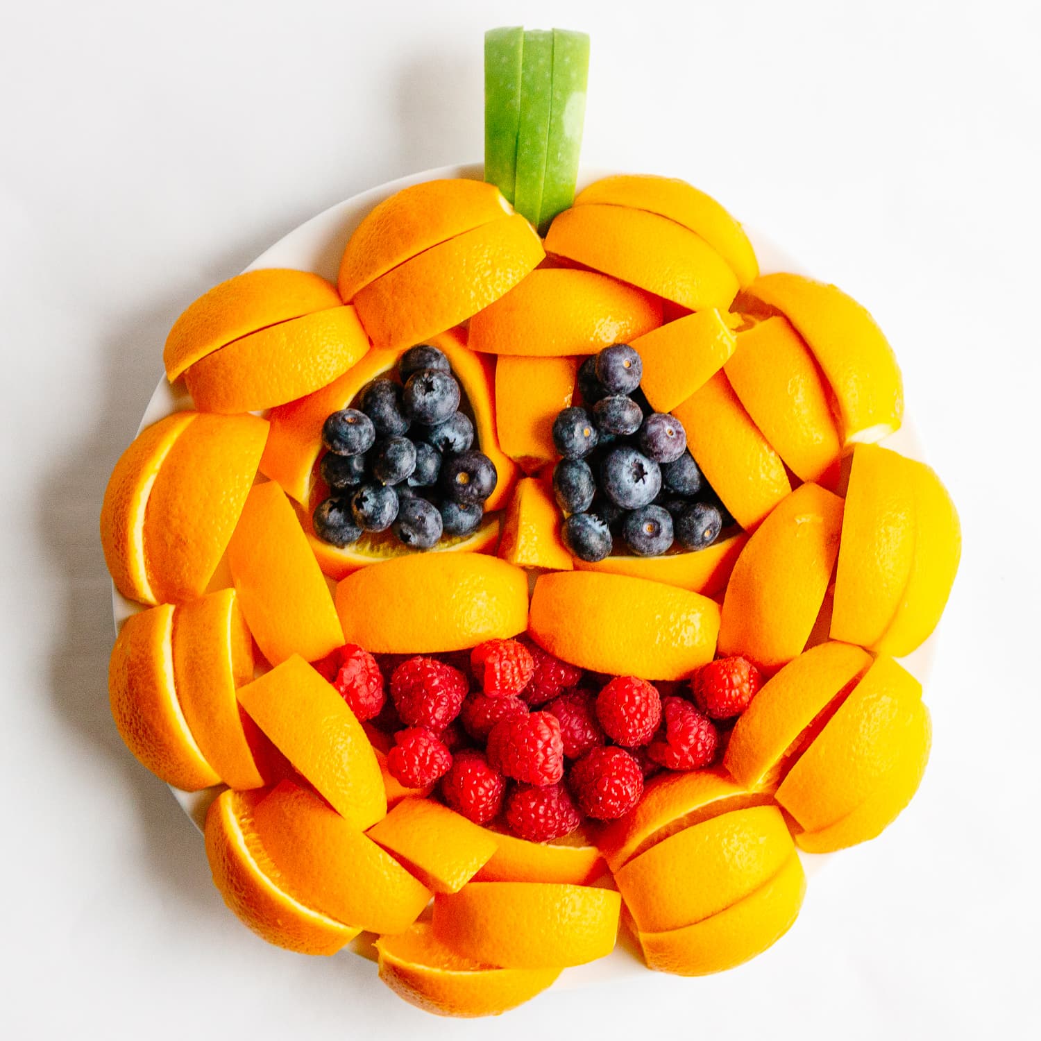 A fruit tray arranged to look like a jack o' lantern.