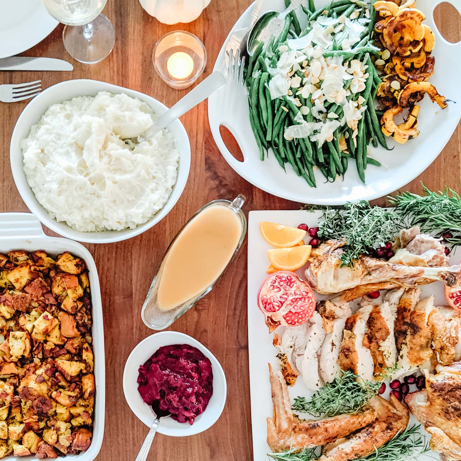 Overhead photo of a turkey dinner on a wood dining table.