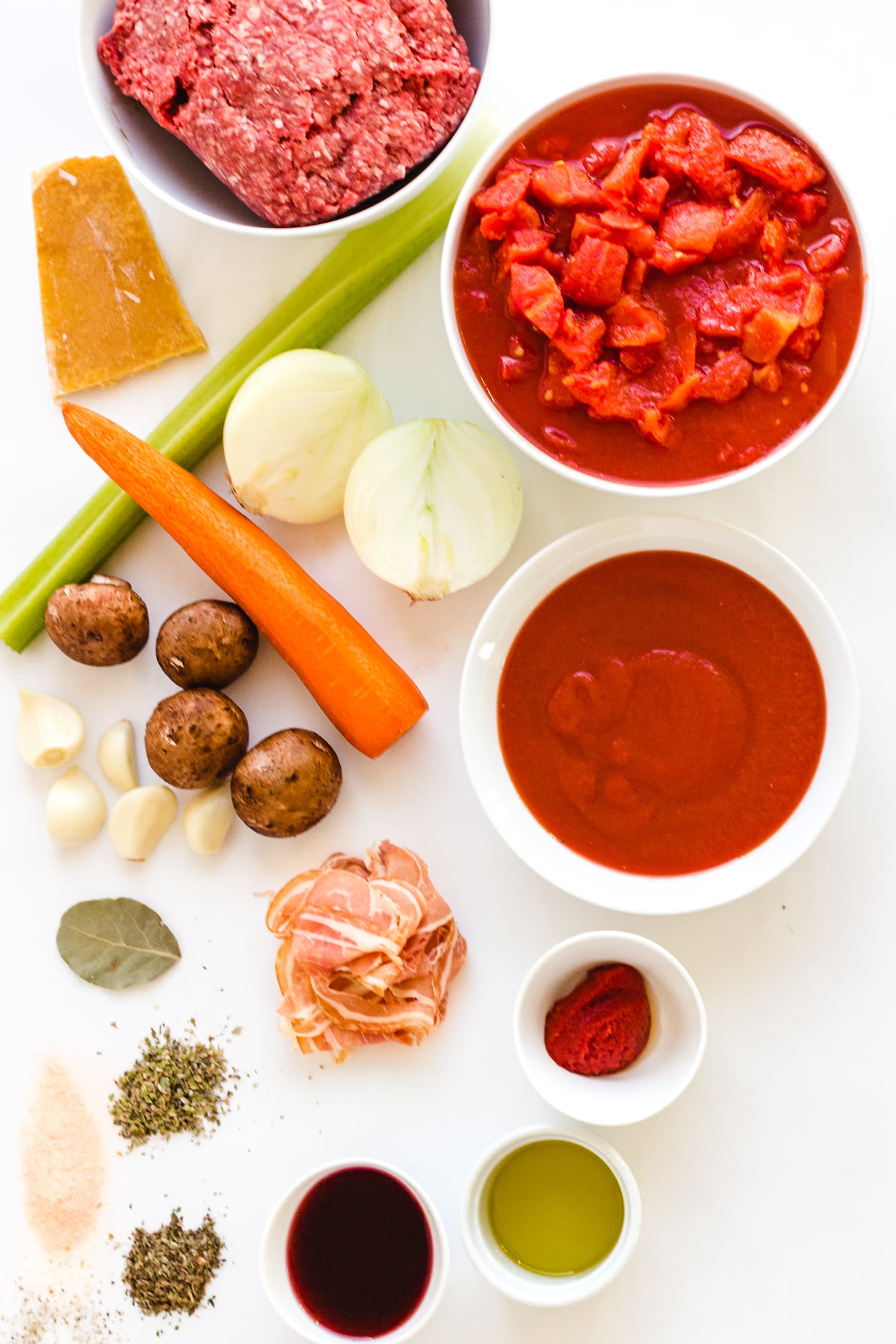 Overhead shot of all the ingredients needed to make bolognese sauce