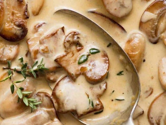 Closeup picture of mushroom sauce with a spoon.