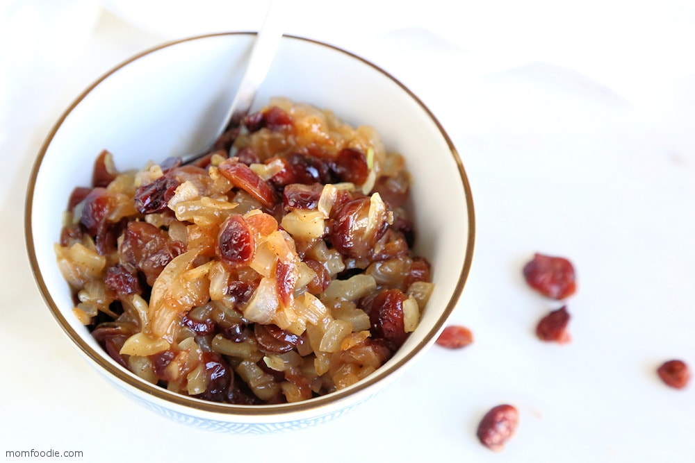 Cranberry Chutney in a bowl with spoon dipped in.