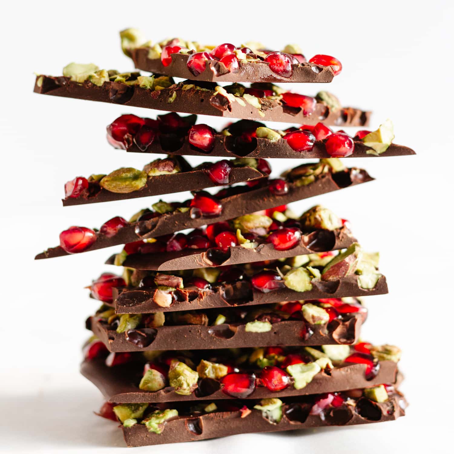 A stacked pile of pomegranate and pistachio chocolate bark.