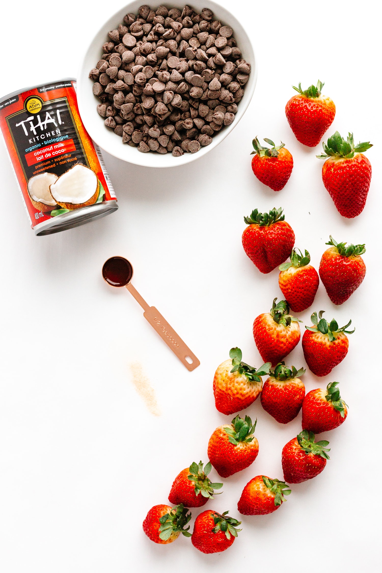 Flatlay showing ingredients needed to make chocolate coconut cream stuffed strawberries.