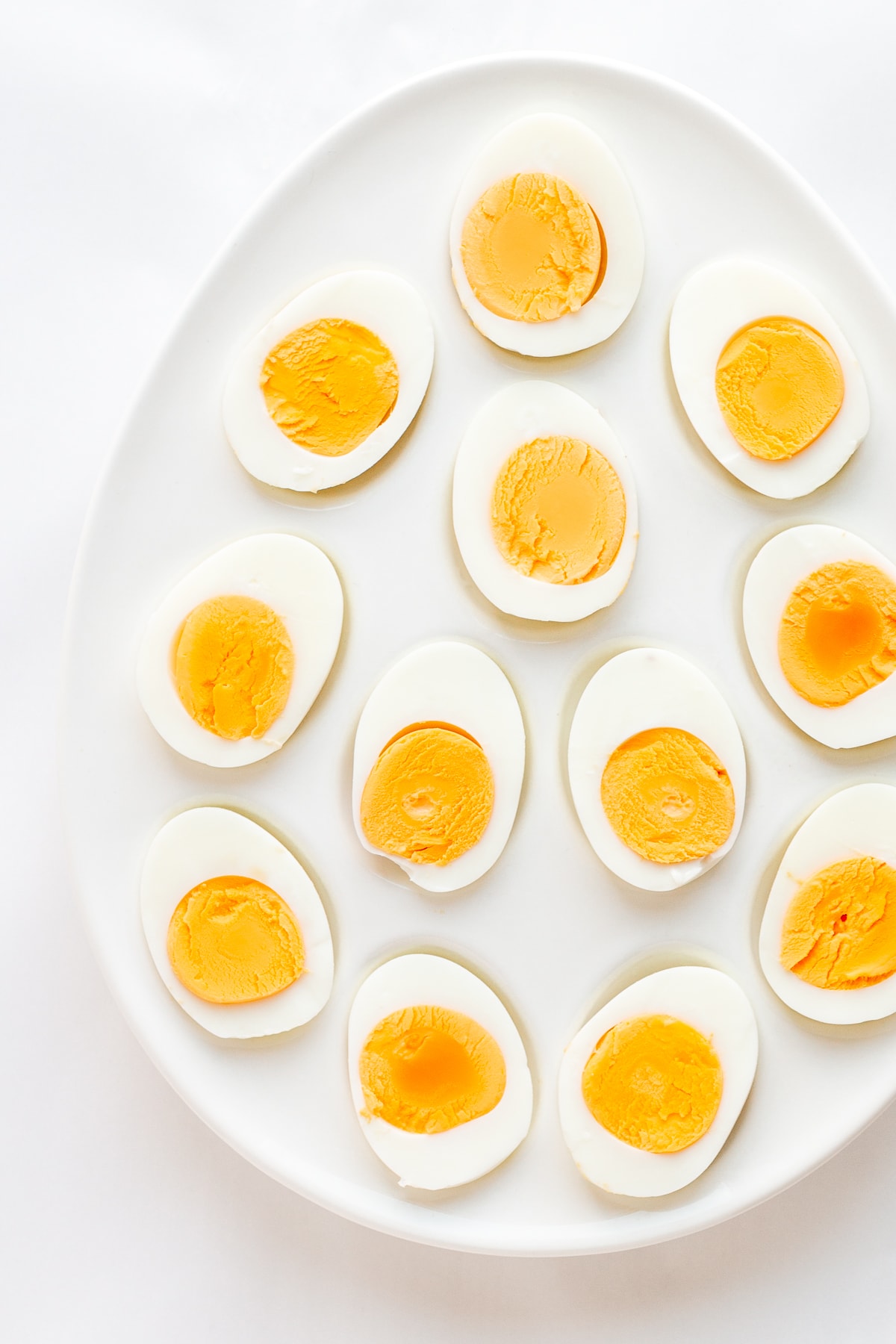 Platter of hard boiled eggs cut in half.