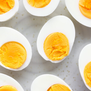 Closeup of halved hard boiled eggs on a plate.
