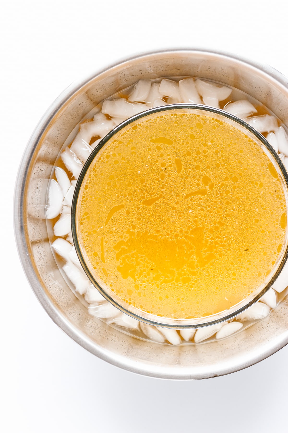 Bowl of broth/stock sitting in an ice bath.