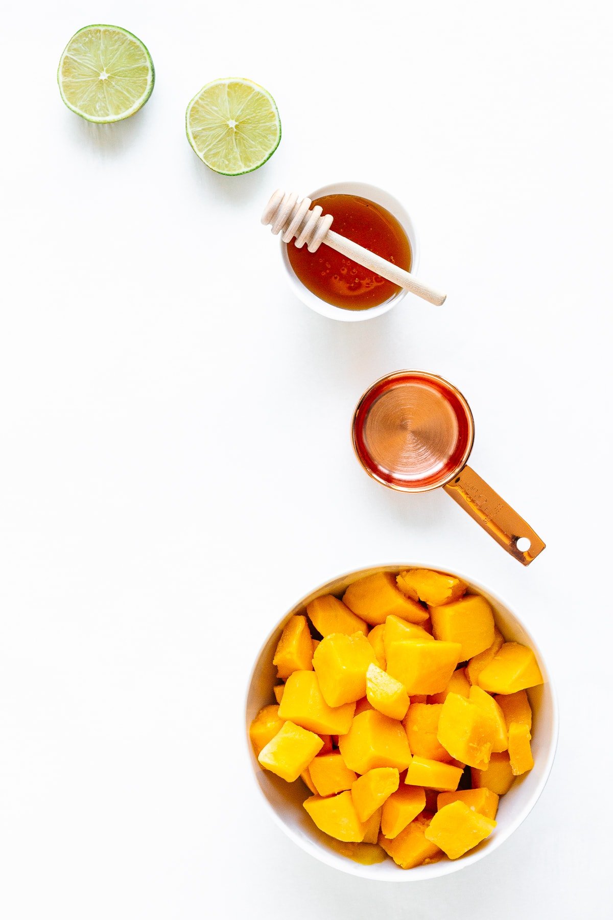 Overhead photo of ingredients needed to make healthy mango popsicles.