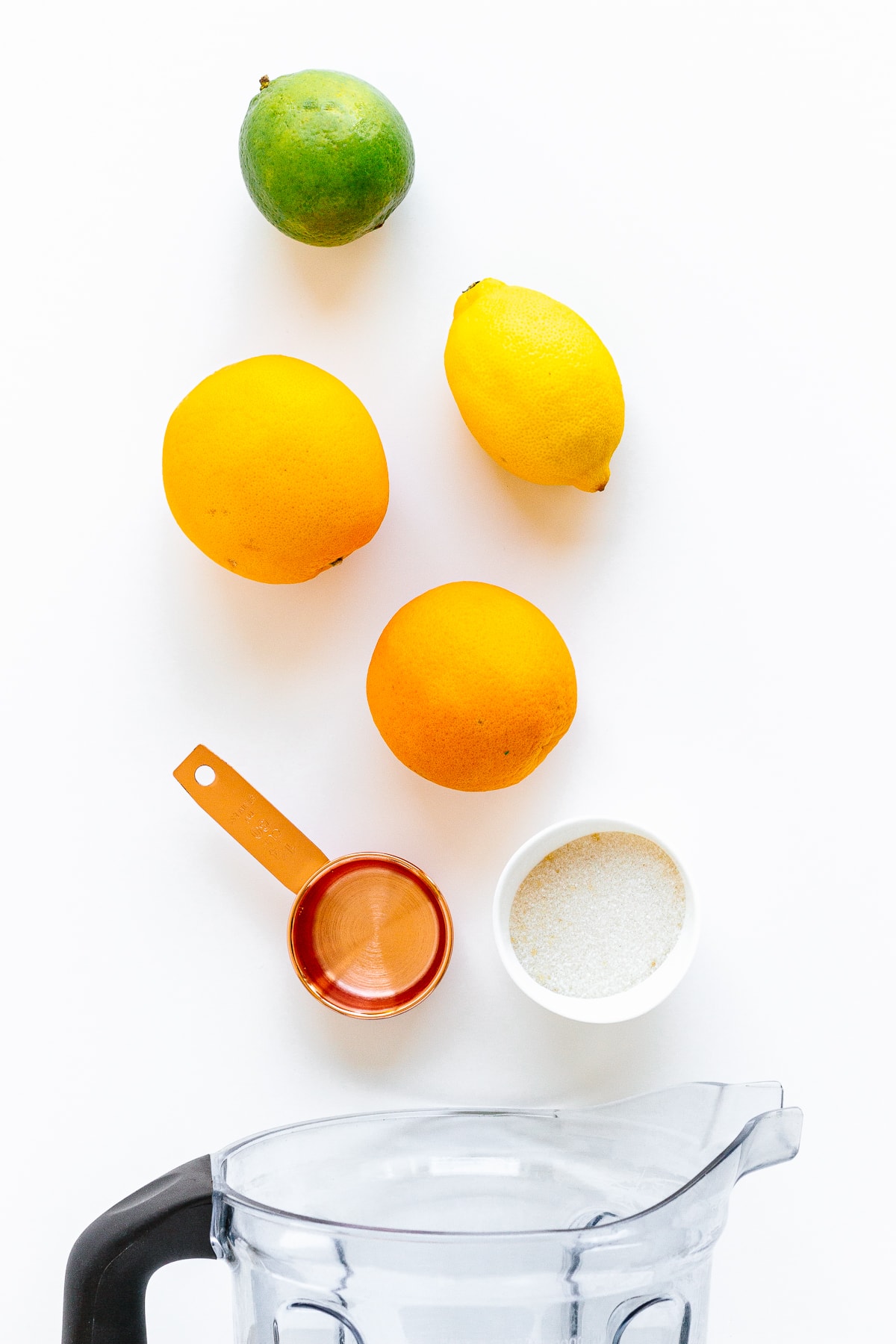 Overhead photo of ingredients needed to make orange lemon lime popsicles.