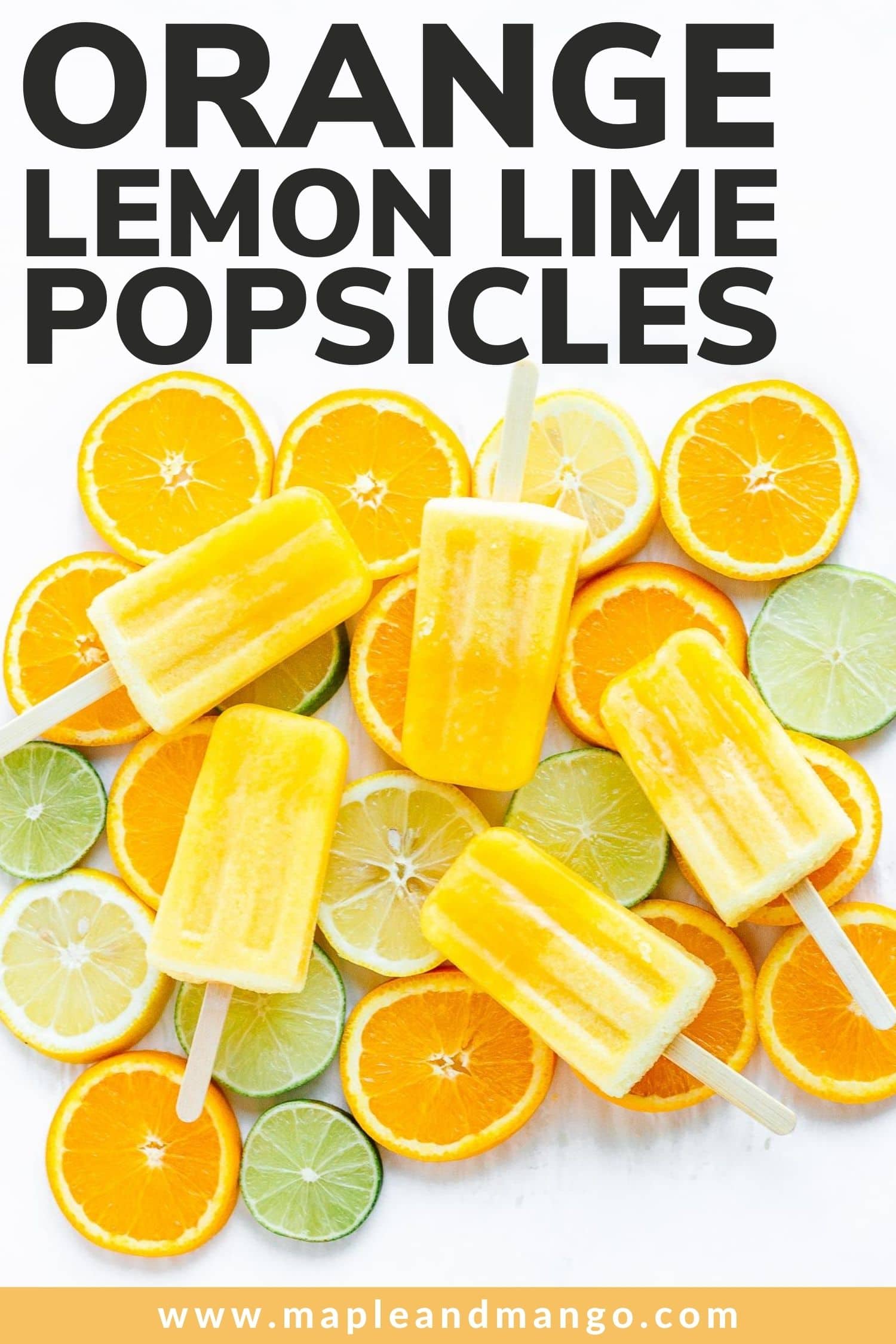 Five popsicles set on top of a variety of sliced citrus with text overlay "Orange Lemon Lime Popsicles".