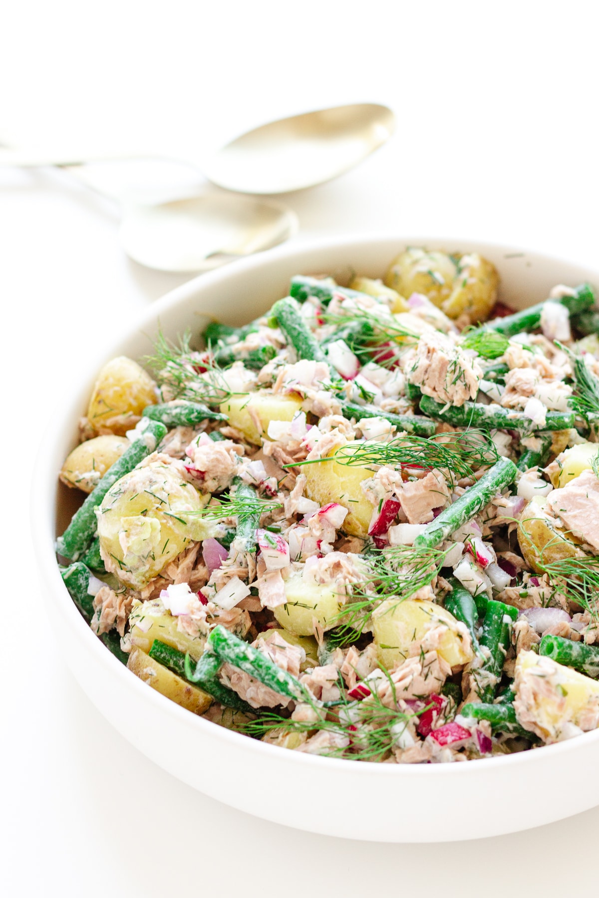 White bowl of tuna potato salad.