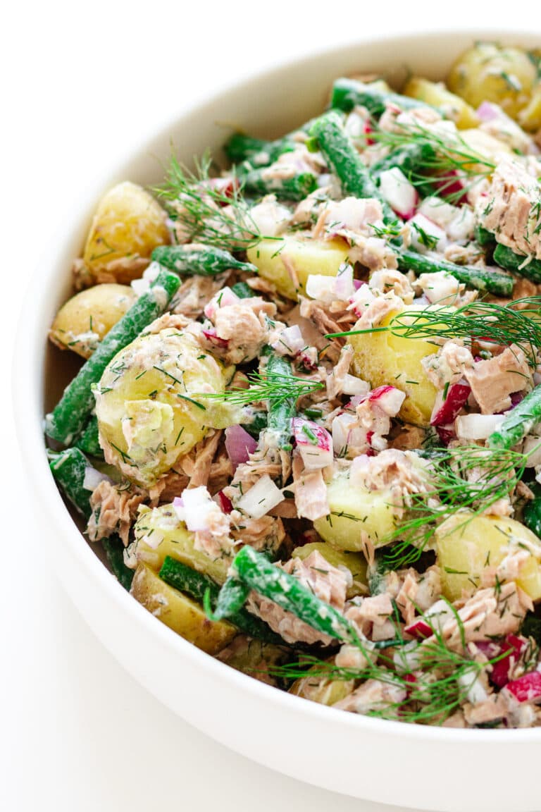 Tuna potato salad in a large white serving bowl.