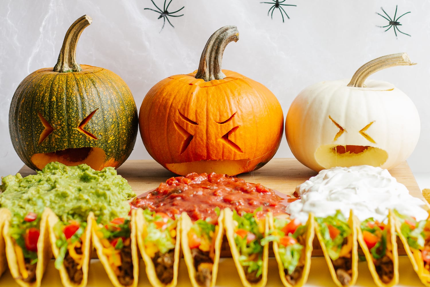 A taco board with a trio of puking pumpkins.