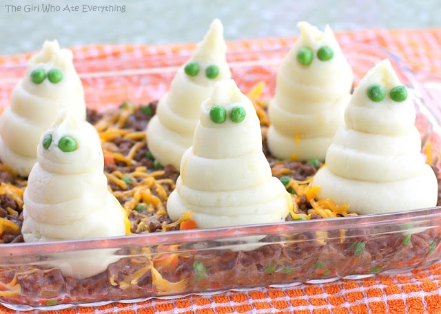 Spooky shepherds pie with mashed potato ghosts.