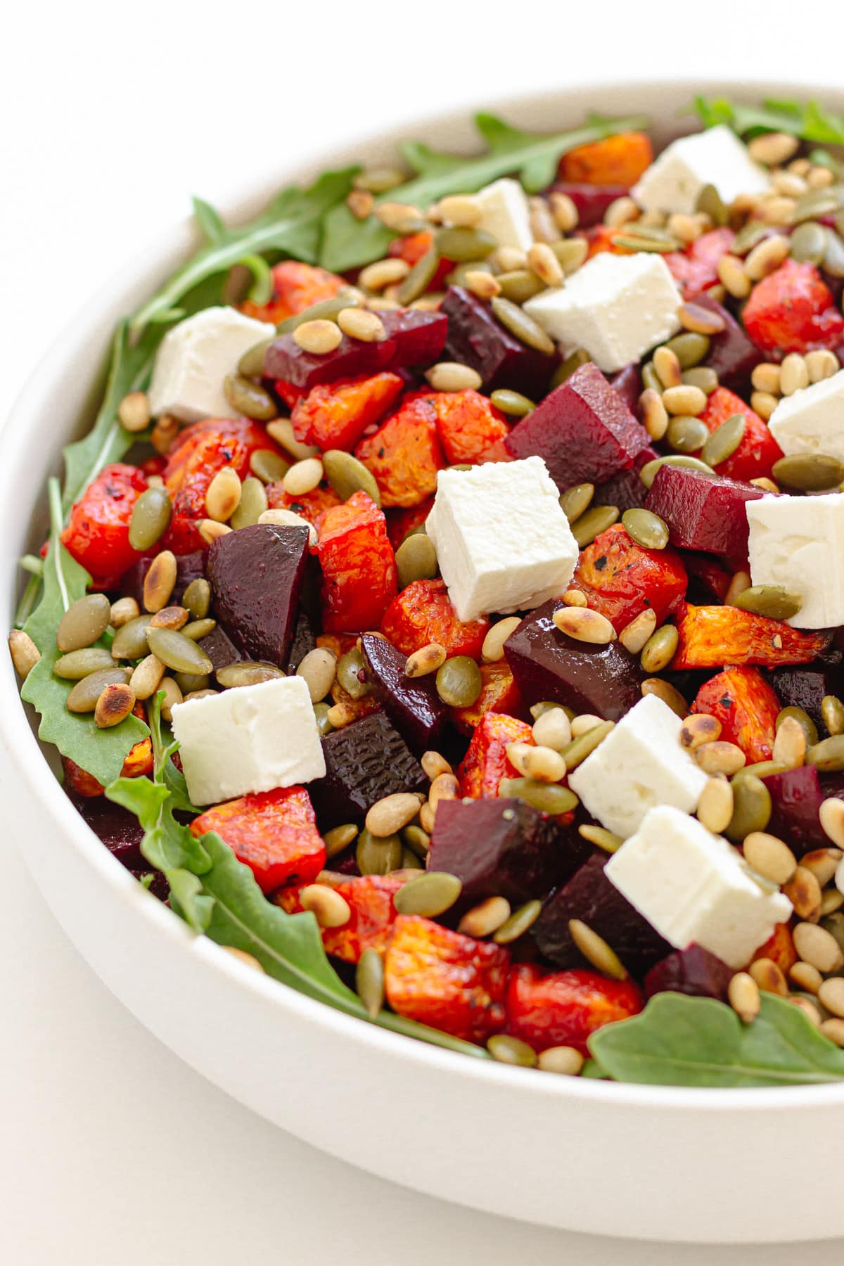 Serving bowl of pumpkin and beetroot salad.