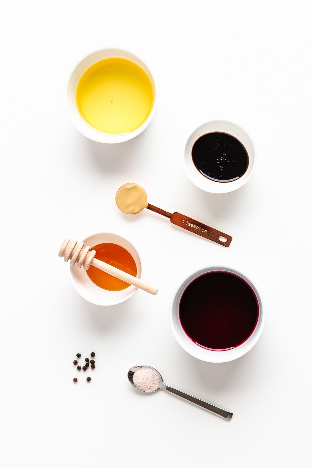 Overhead photo of ingredients needed to make a homemade pomegranate salad dressing.