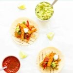 Three halloumi fajitas with toppings and text overlay "Halloumi Veggie Fajitas".