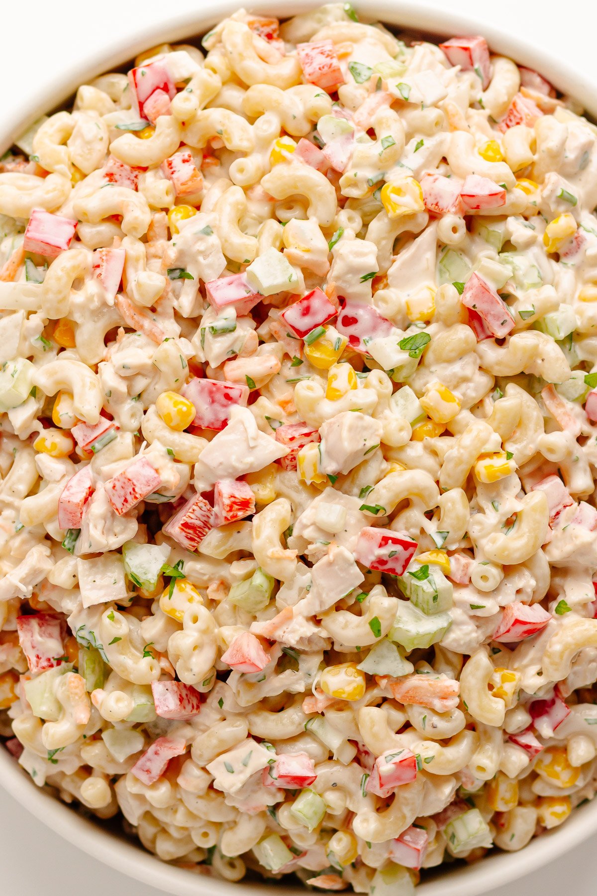 Chicken macaroni salad in a white serving bowl.