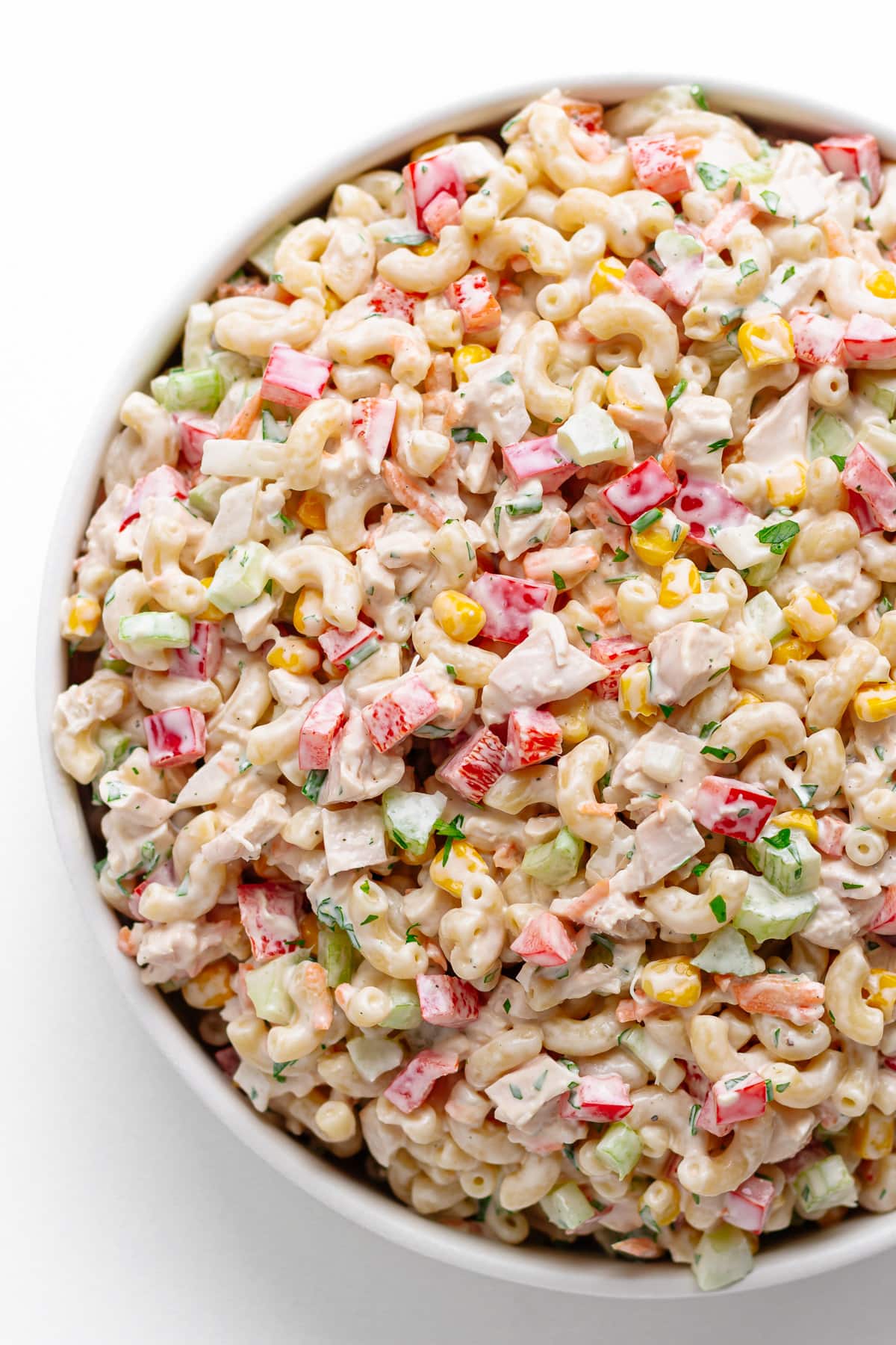 Chicken macaroni salad in a large shallow white serving bowl.