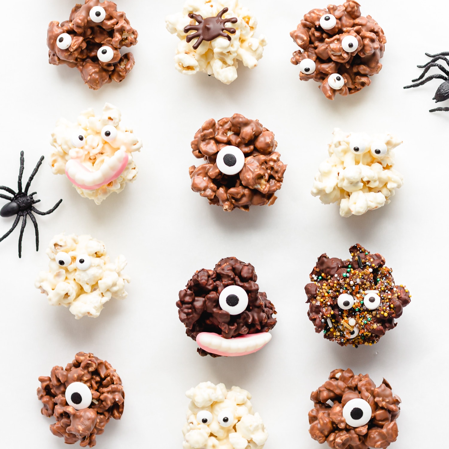 A variety of different chocolate popcorn balls decorated for Halloween.