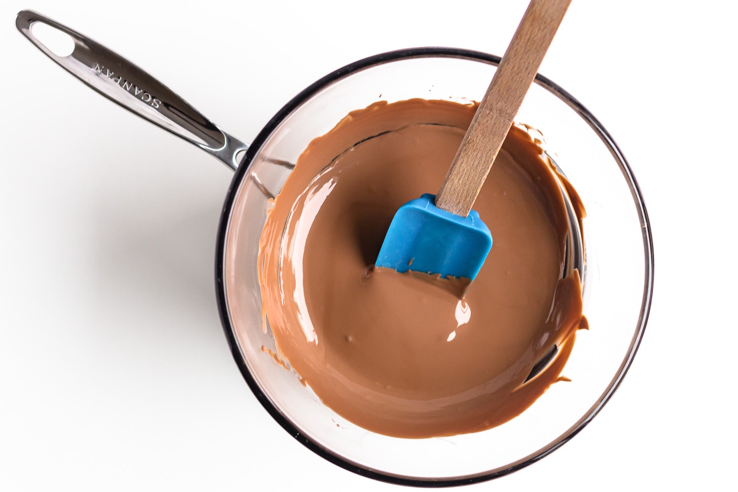 Glass bowl of melted chocolate over small pot of simmering water.