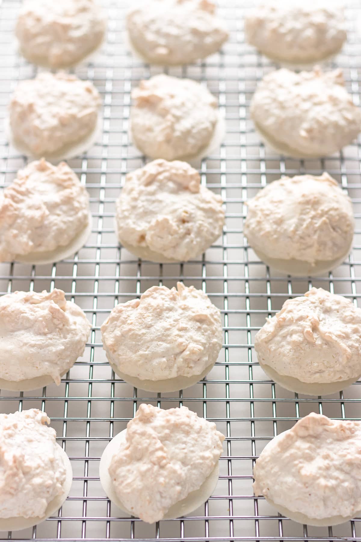 Coconut macaroon cookies on a wire cooling rack.