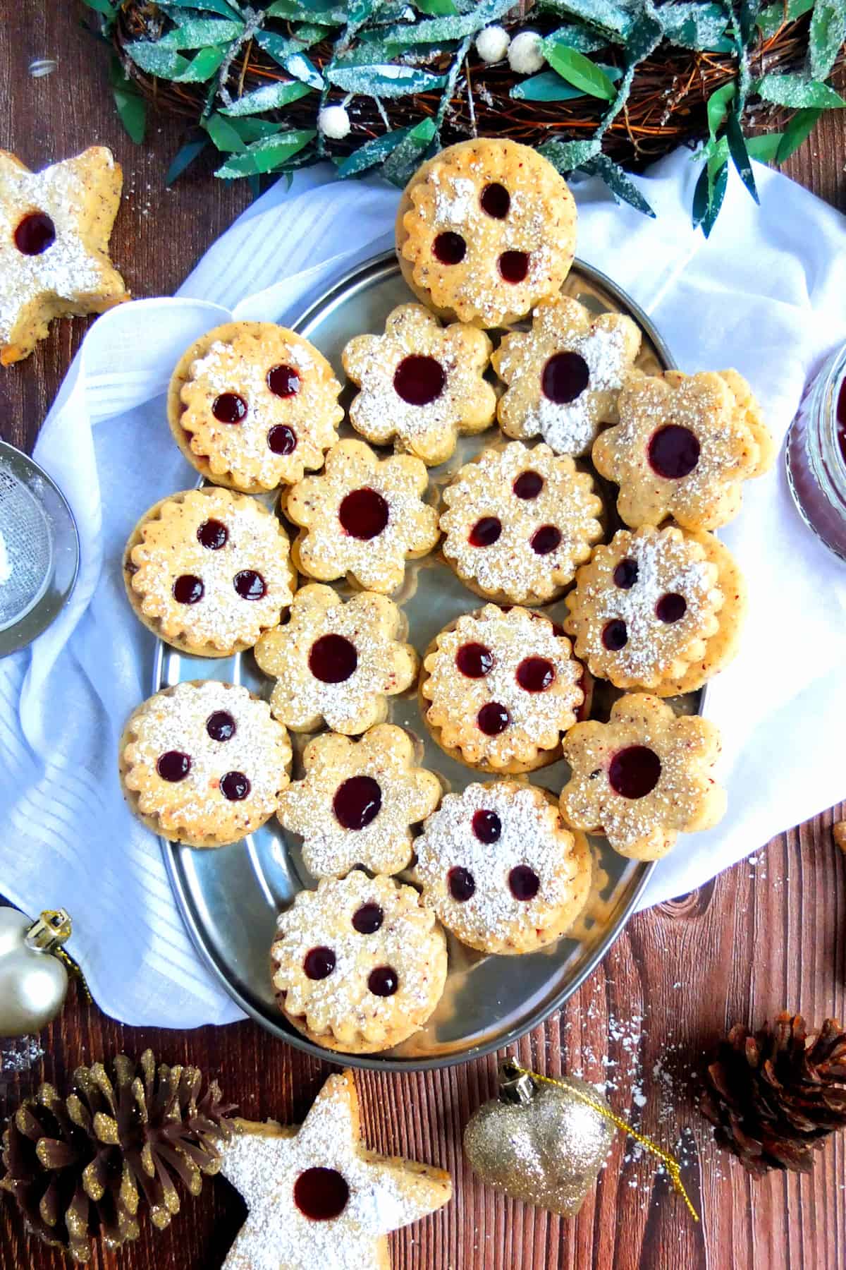 Variety of Spitzbuben cookies on a Christmas platter.