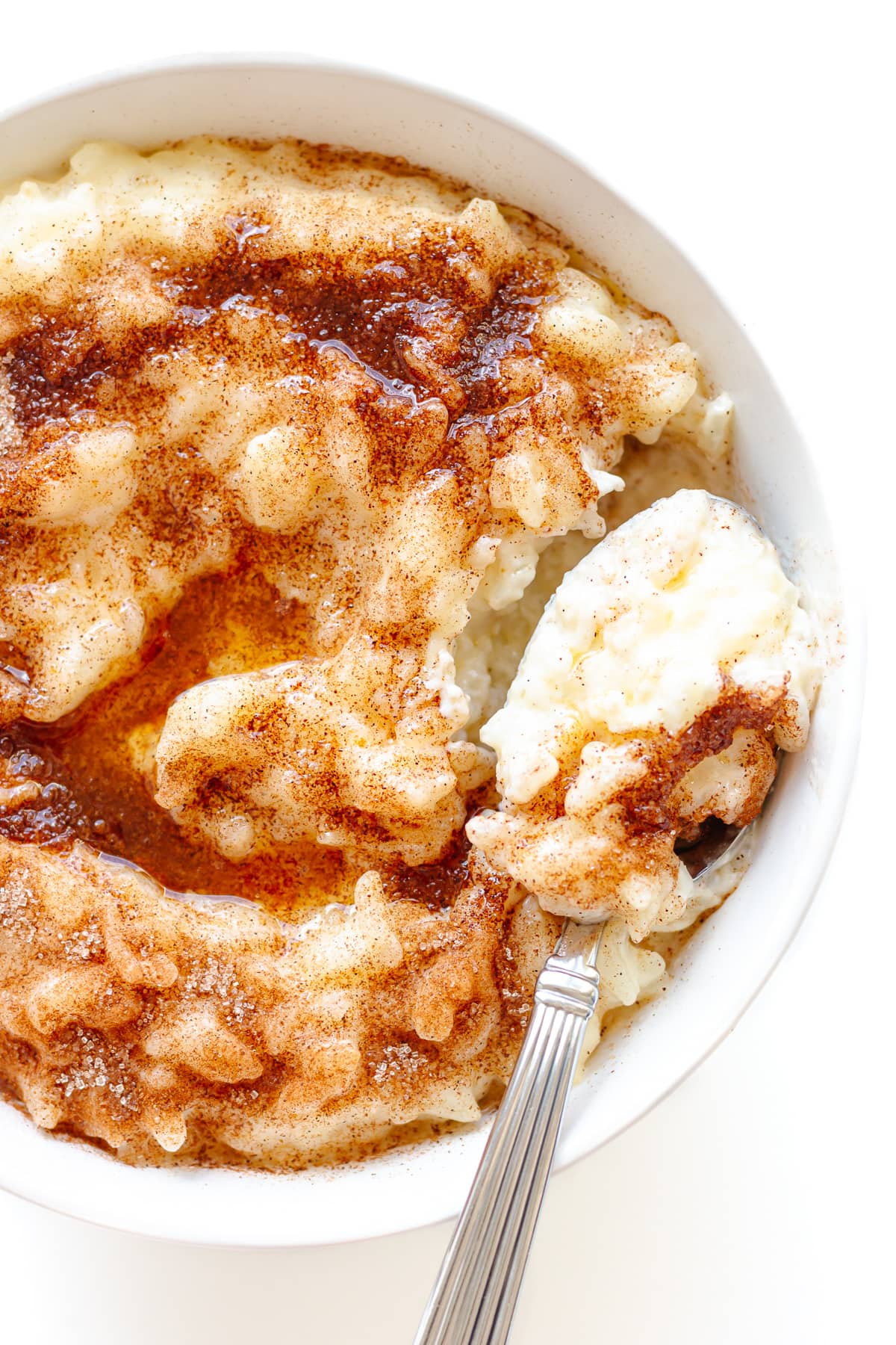 Bowl of Milchreis (aka German Rice Pudding) topped with cinnamon, sugar and brown butter.