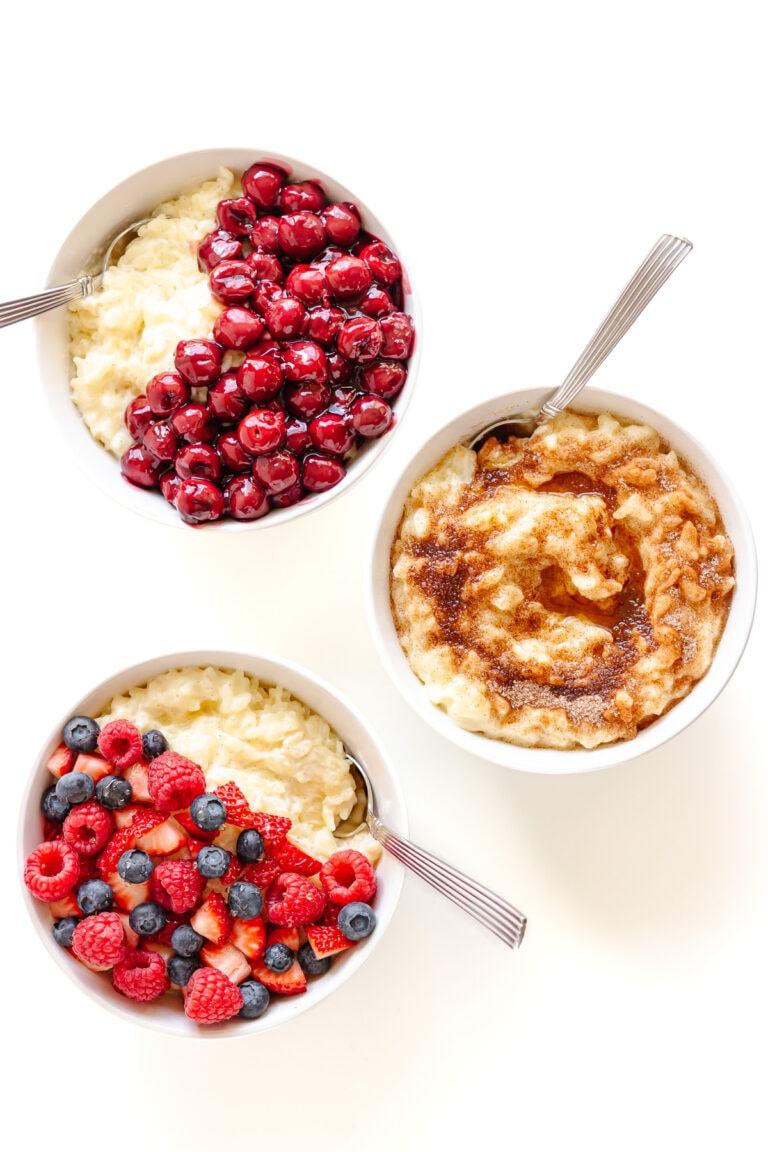 Three bowls of german milk rice pudding with different toppings.