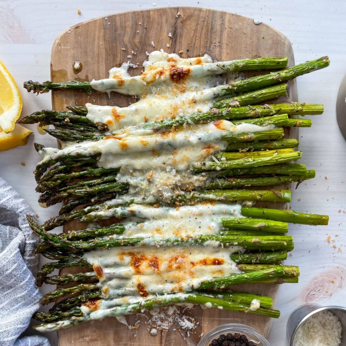 Garlic cheese asparagus on a wooden board.