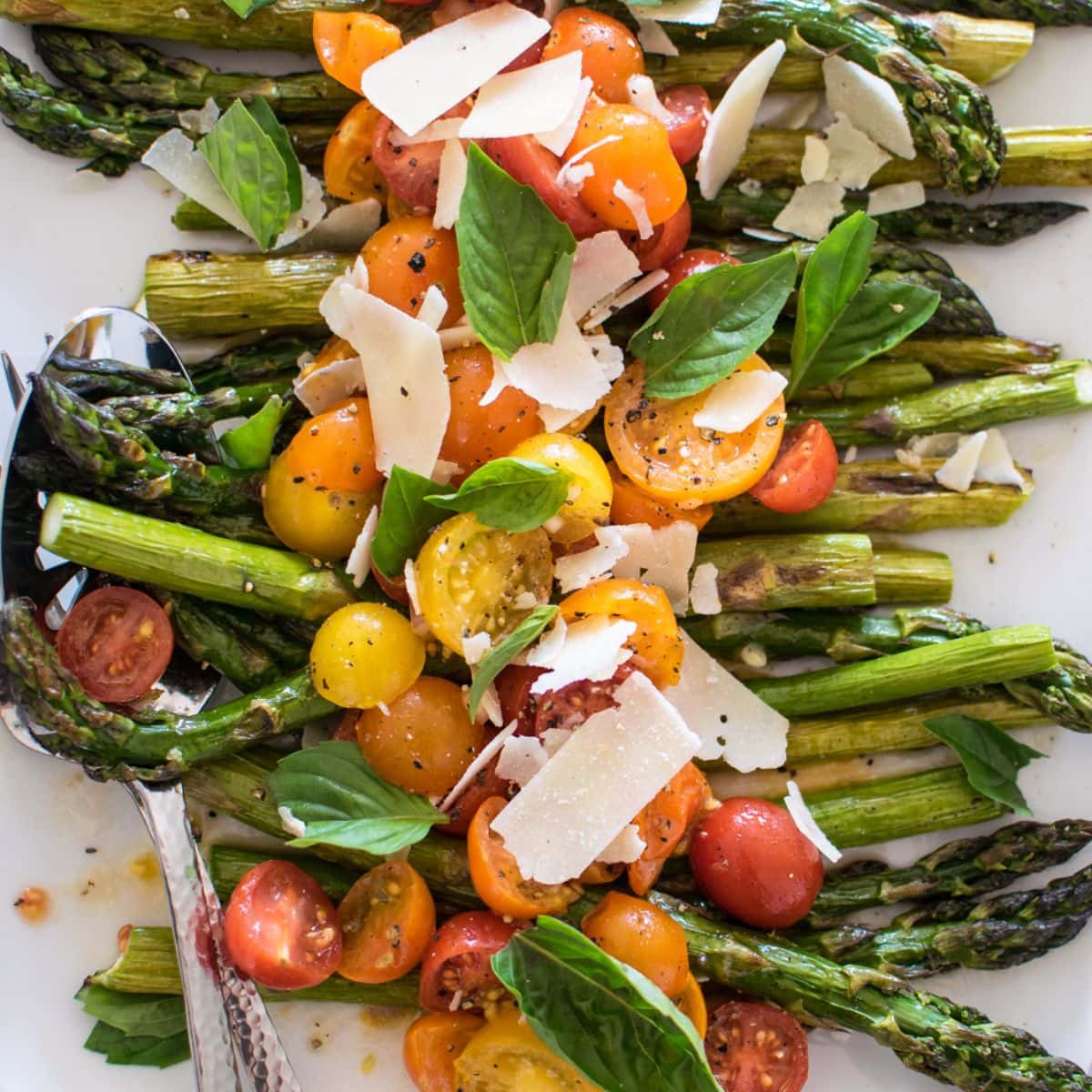 Closeup of roasted asparagus and tomato salad.