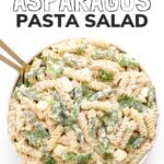 Pasta salad in a white serving dish with text overlay "Salmon Asparagus Pasta Salad".