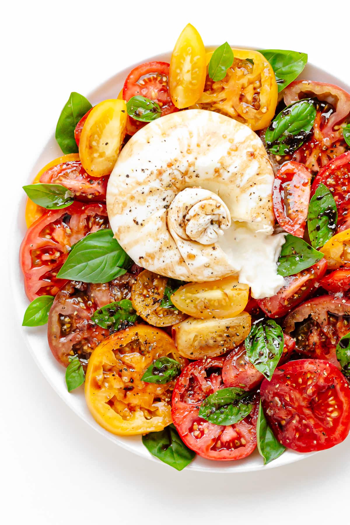 A plate of burrata caprese salad.