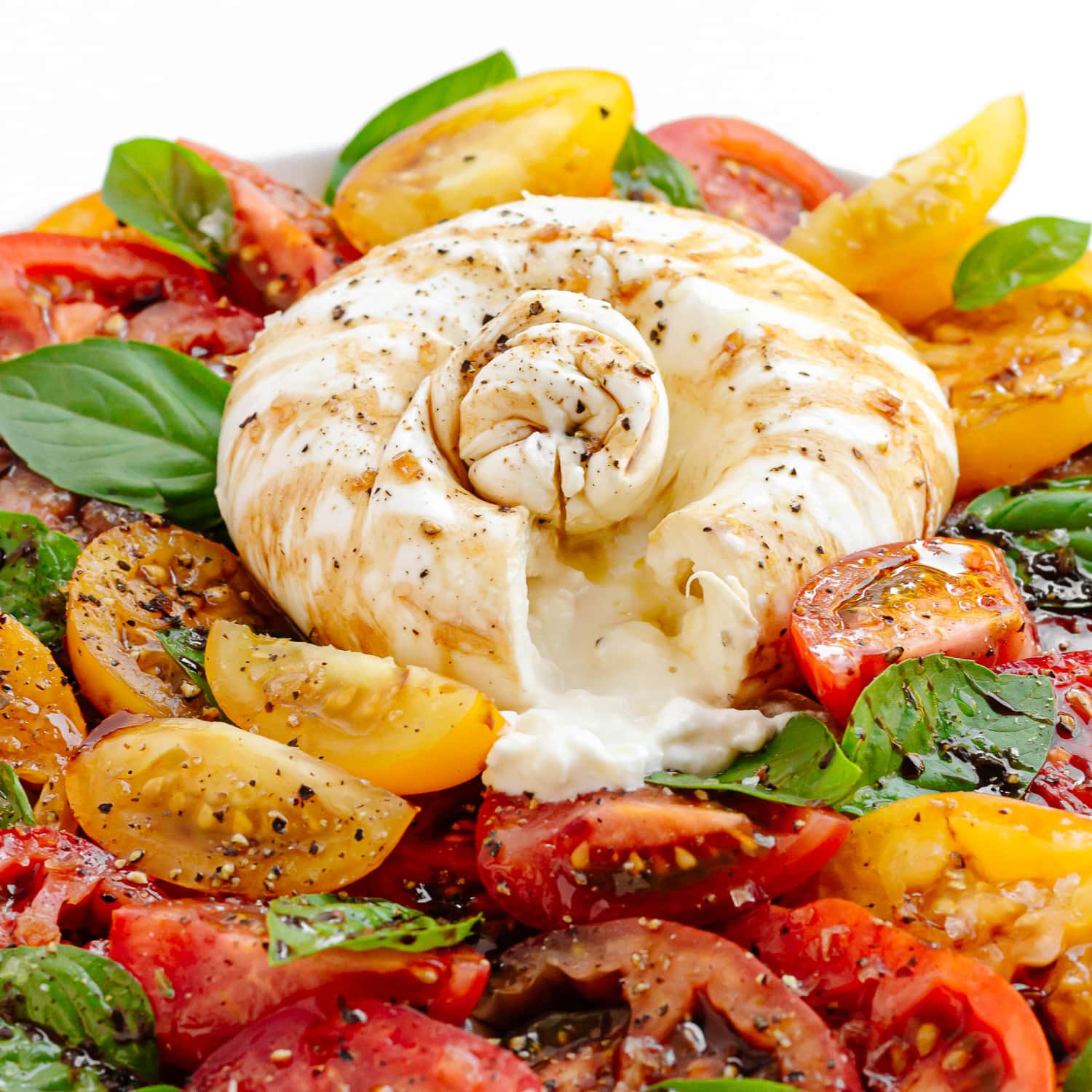 Closeup of burrata tomato salad.