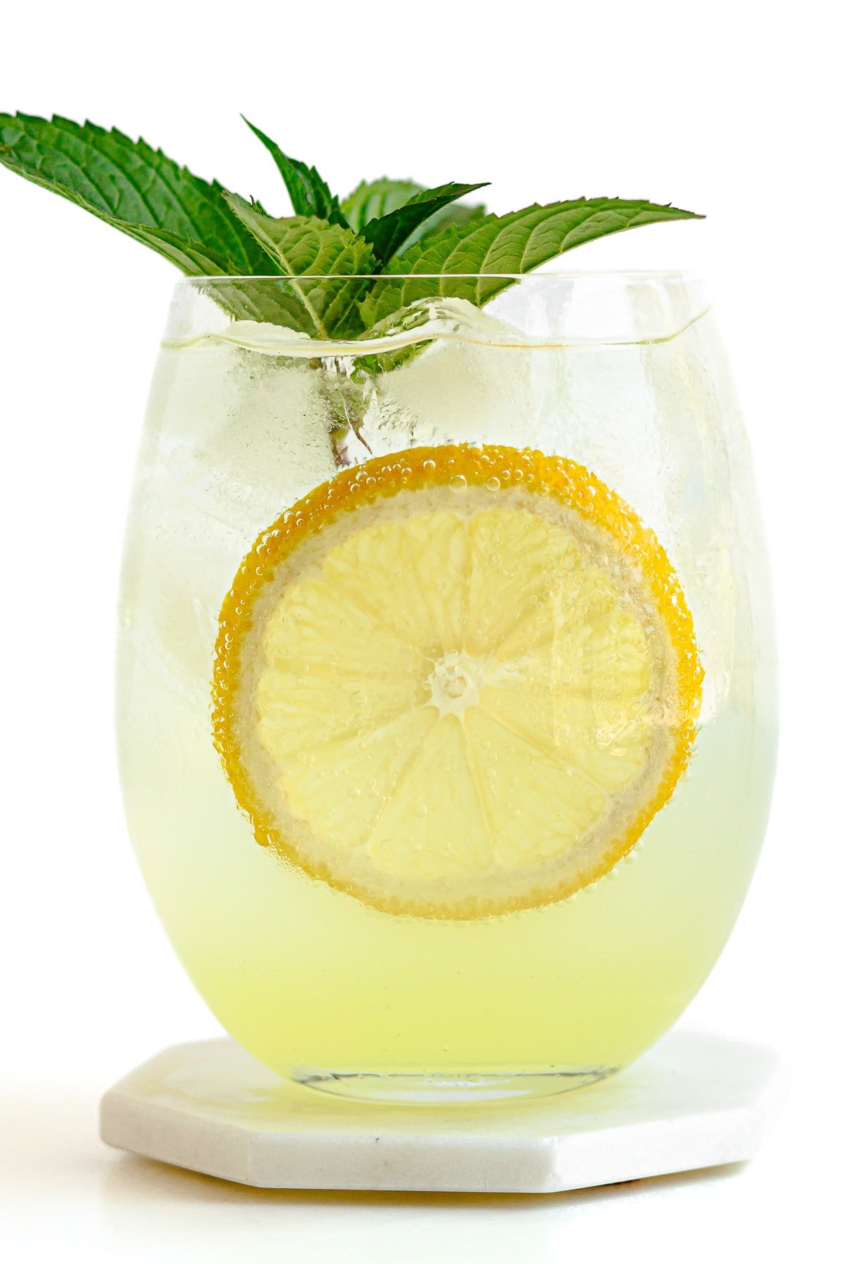 Glass of limoncello spritz garnished with fresh mint and a slice of lemon.