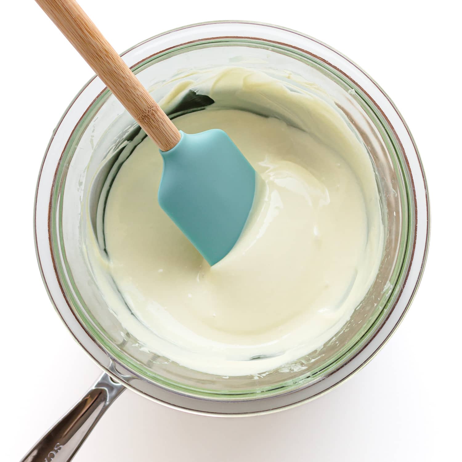 Melting white chocolate in a glass bowl set over a small pot of barely simmering water.