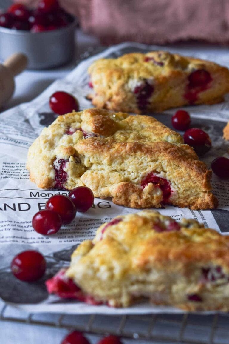 Cranberry Orange Cream Scones set on printed recipe sheets.