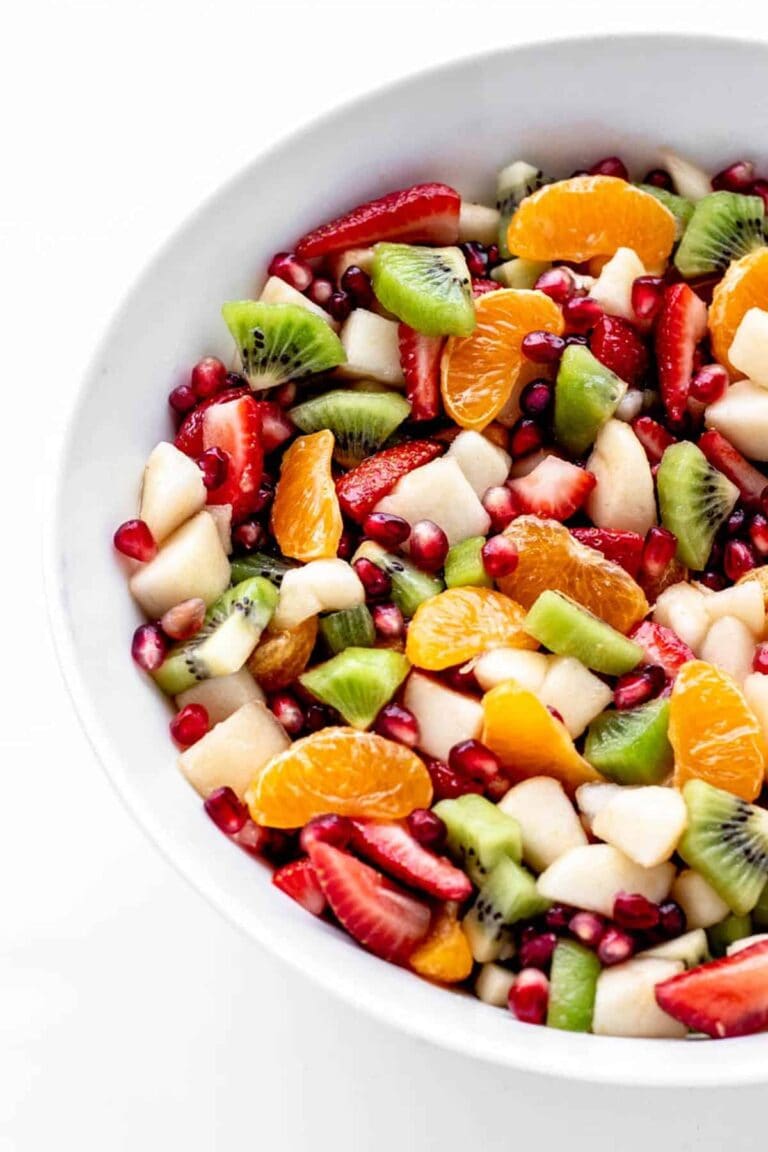 Christmas fruit salad in a white serving bowl.