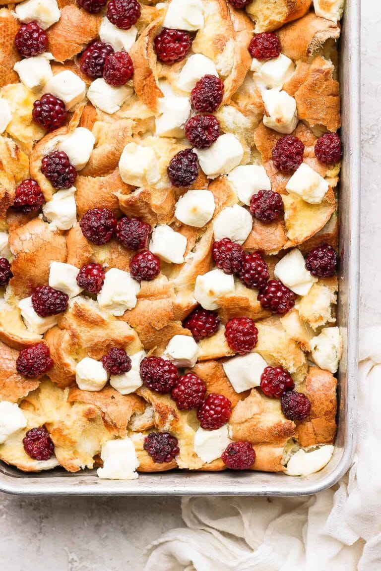 French toast bake with cream cheese and raspberries on top.