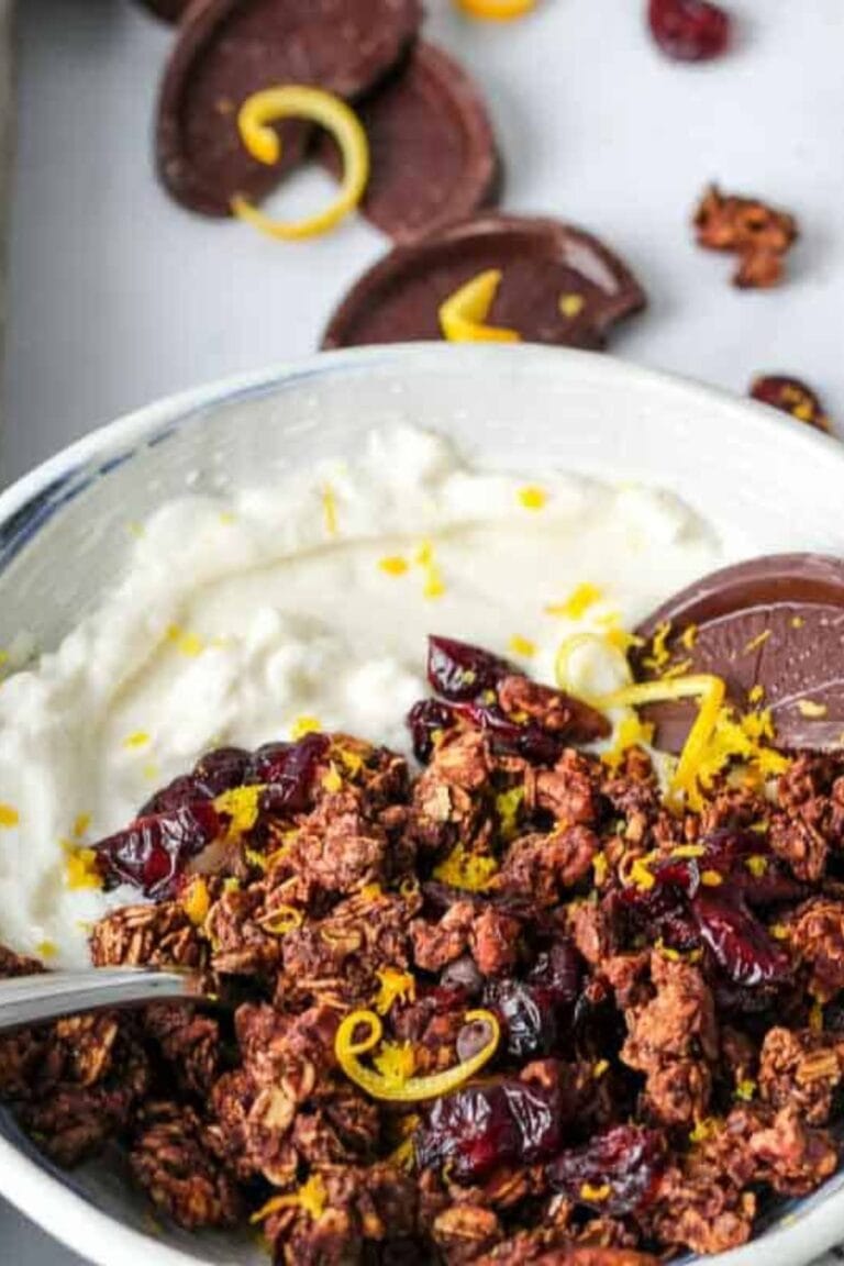 Orange chocolate granola and yogurt in a bowl.