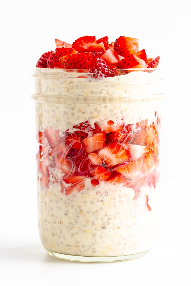 Layered strawberry overnight oats in a glass mason jar.