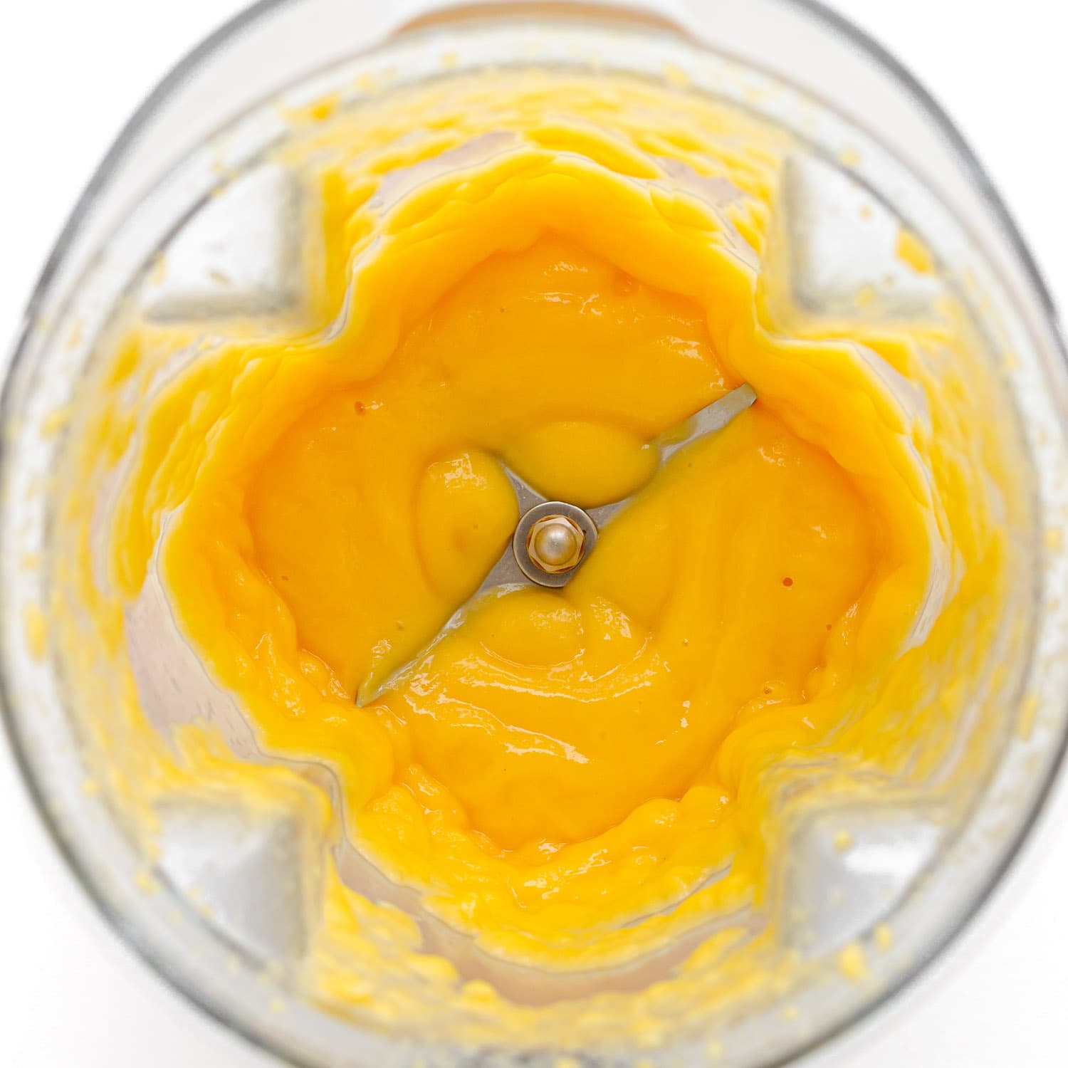 Pureed mango in a blender.