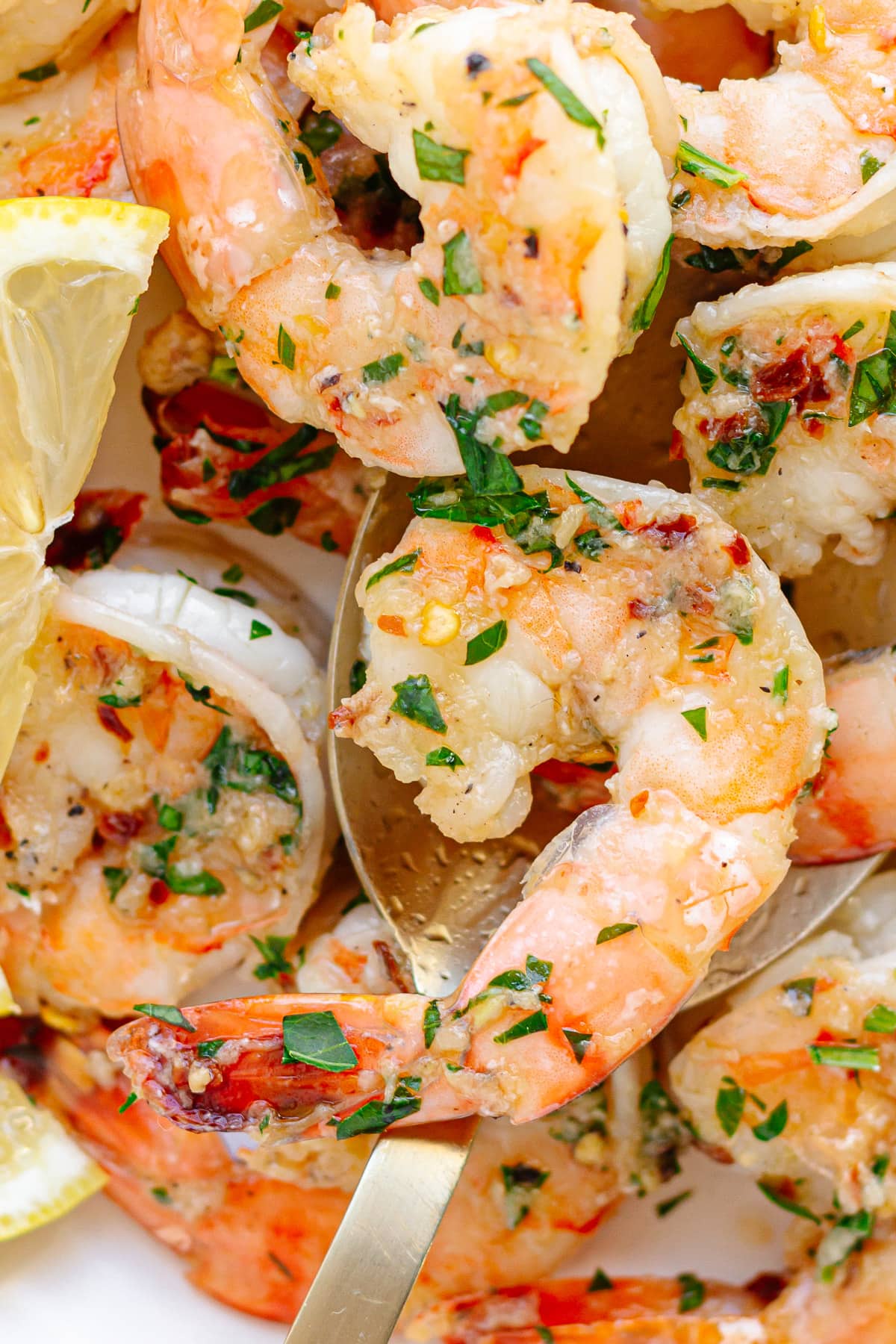 Closeup of garlic ginger pan seared shrimp on a serving spoon.