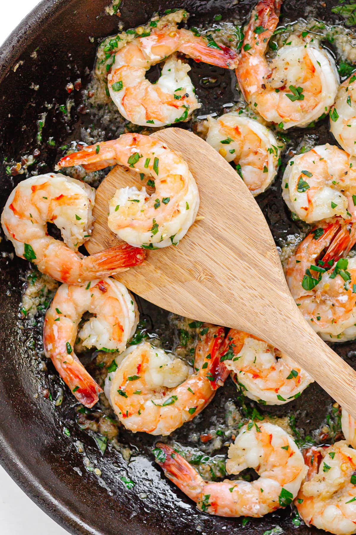 Pan fried shrimp in a cast iron skillet.